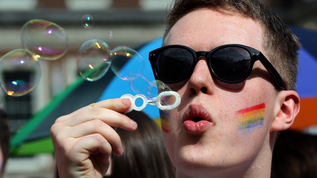 A man blows bubbles as supporters for same-sex marriage wait for the result of the referendum at Dublin Castle