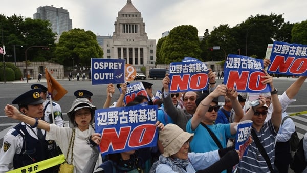 Demonstrators are angry over plans to build a new US airbase in Okinawa