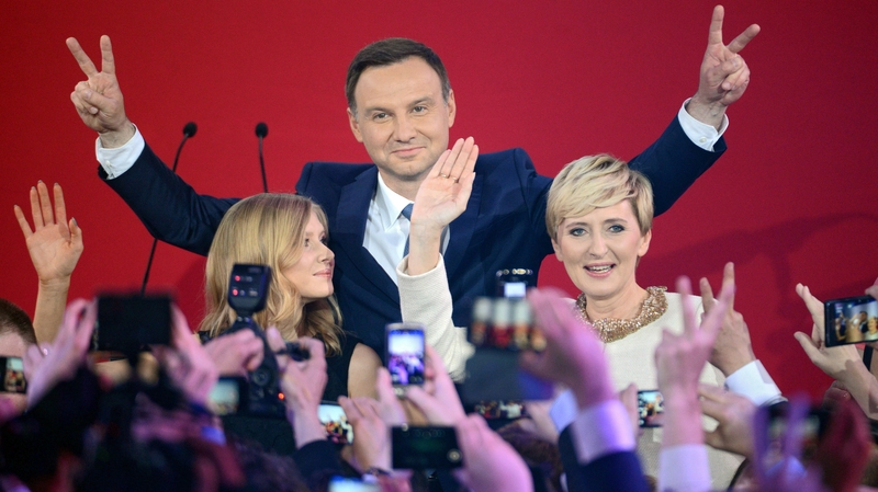 Andrzej Duda with his wife Agata Kornhauser-Duda react on the first projections during presidential election night in Warsaw
