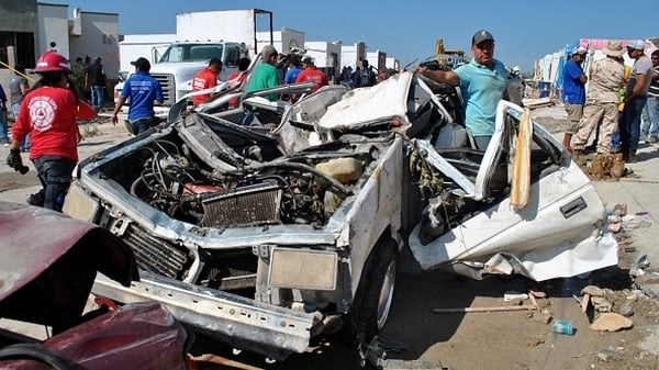 The tornado flipped over cars and knocked down homes