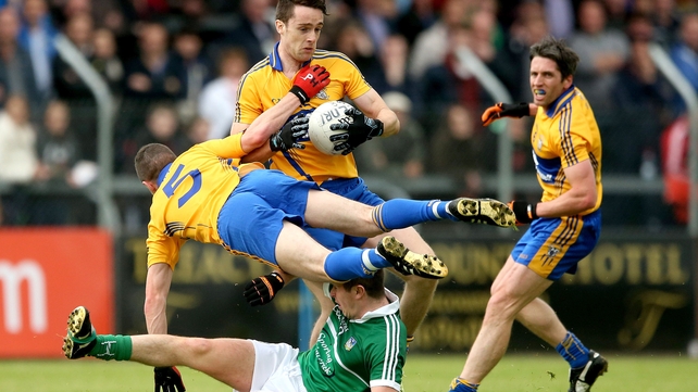 Clare’s Shane Brennan and Shane Hickey with John Riordan of Limerick during thier Munster SFC quarter-final on Saturday