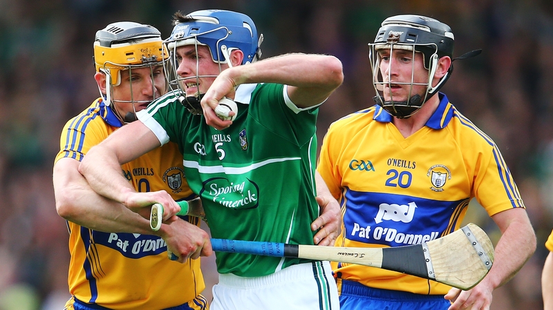 Limerick's Gavin O’Mahony feels the pressure from his Clare minders at Semple Stadium last weekend