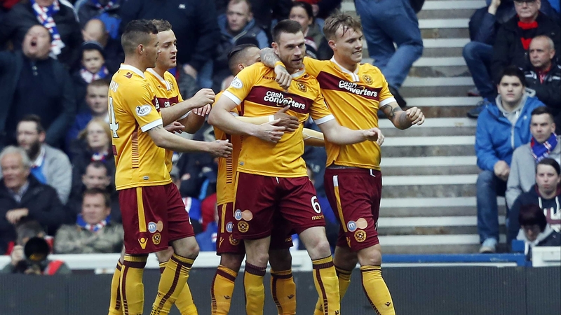 Stephen McManus is congratulated by his Motherwell team-mates after scoring his side's second goal at Ibrox