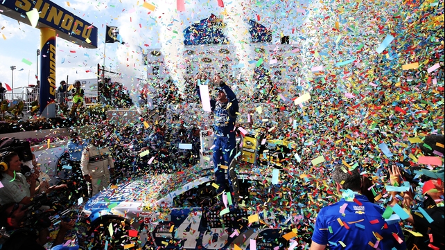 Jimmie Johnson celebrates in Victory Lane after winning the NASCAR Sprint Cup Series FedEx 400 at Dover International Speedway