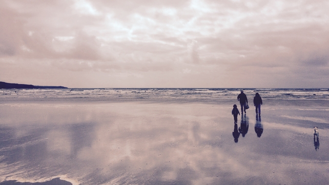 A family and their dog walk along a beach in Co Donegal (Pic: Stephen Crowley)