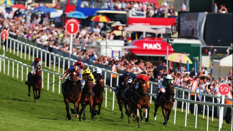 Qualify (red and yellow) comes through late on to win the Oaks