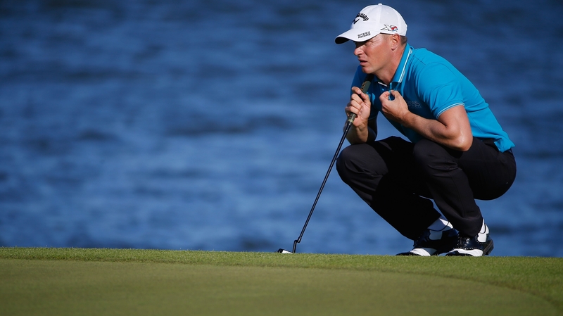 Alex Noren lines up a putt on the seventeenth hole