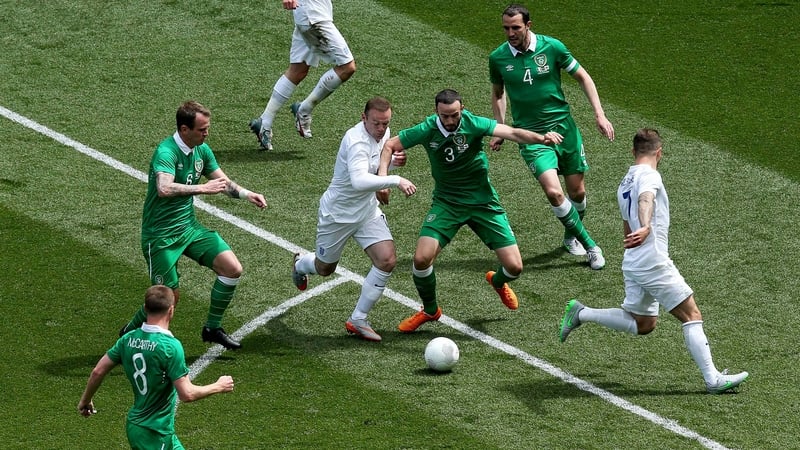England captain Wayne Rooney and Ireland's Marc Wilson battle for possession