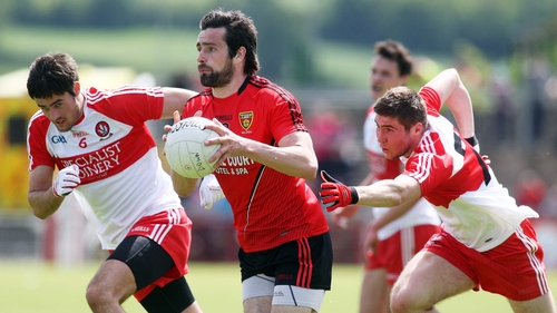 Down's Kevin McKernan has Derry's Christopher McKaigue and Ciaran McFaul (right) in pursuit at Celtic Park