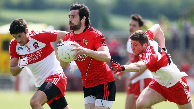Down's Kevin McKernan has Derry's Christopher McKaigue and Ciaran McFaul (right) in pursuit at Celtic Park