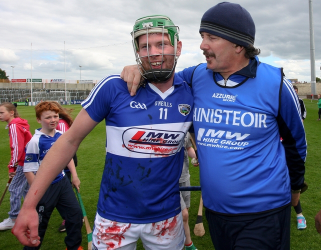 Blood, sweat and cheer: Laois manager Seamus Plunkett is congratulated by Zane Keenan at the end of the game against Offaly