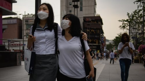 Two women in Seoul. South Korea wear face masks to ward off infection