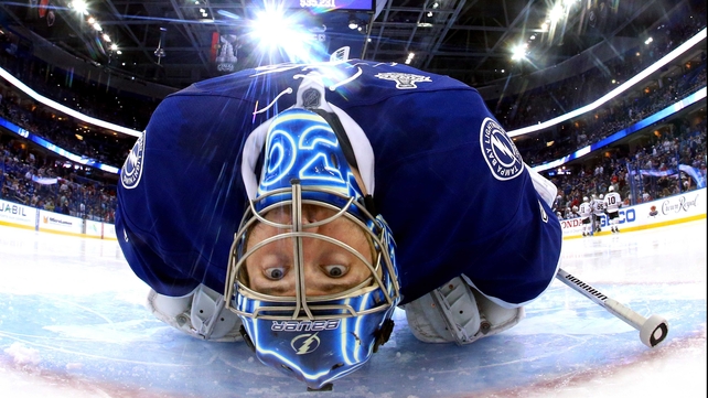 Ben Bishop of the Tampa Bay Lightning stretches during a break in play against the Chicago Blackhawks in game one of the Stanley Cup Final
