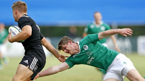 New Zealand's Jack Goodhue evades the tackle of Garry Ringrose of Ireland