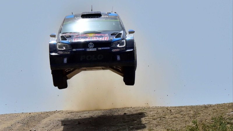 Sebastien Ogier's Volkswagen Polo R takes off at the top of a crest on the Rally Italia Sardegna