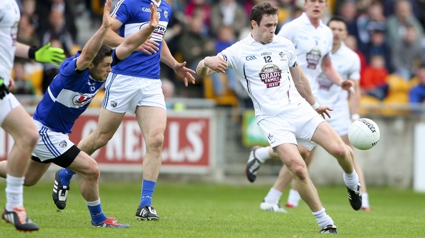 Laois' Brendan Quigley attempts to block Kildare’s Cathal McNally