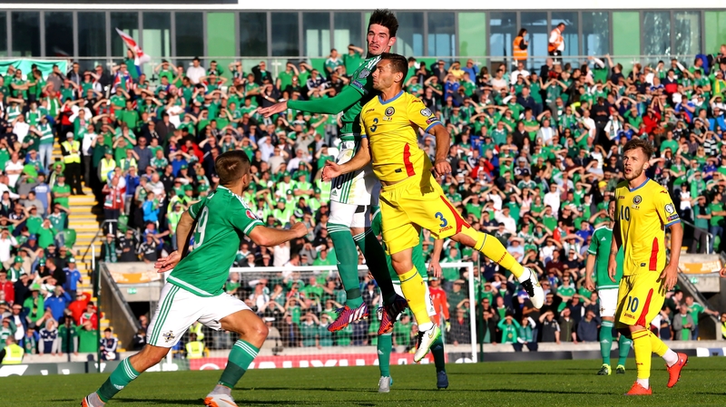 Northern Ireland's Kyle Lafferty with Romania's Laszlo Sepsi