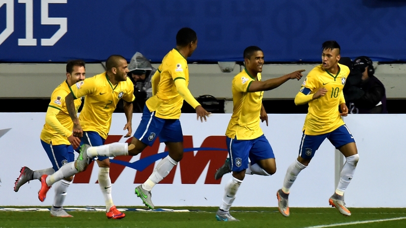 Brazil's Douglas Costa celebrates with Neymar (R) and teammates after scoring against Peru