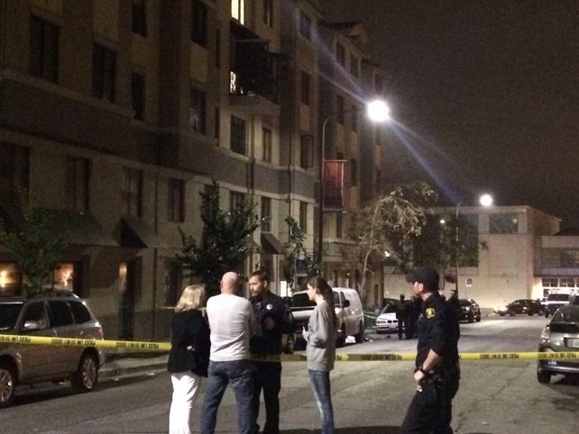 People and police officers stand in the street near the scene of the incident (Pic: @taramoriarty1)