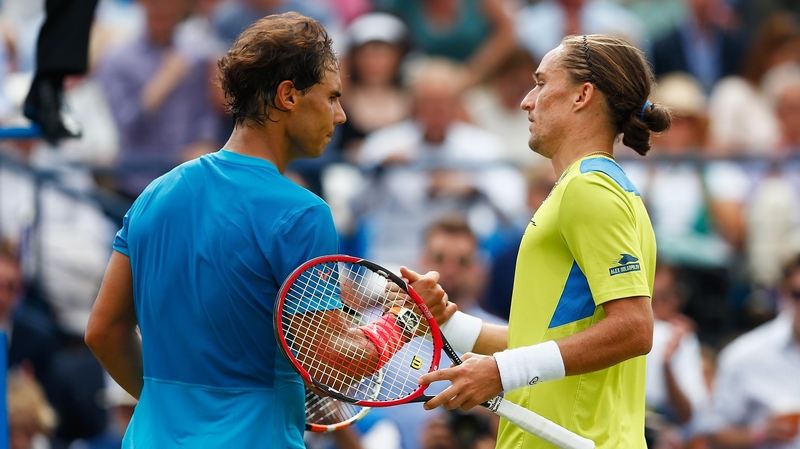 Winner Alexandr Dolgopolov (R) shakes hands with Rafael Nadal
