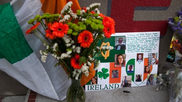 Cards and flowers lay close to the apartment complex