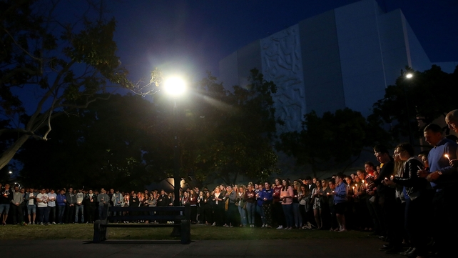 The crowd gathered in silence and formed a large circle in the park