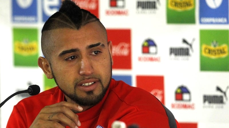 Chile's Arturo Vidal drinks water at a press conference in Santiago last night