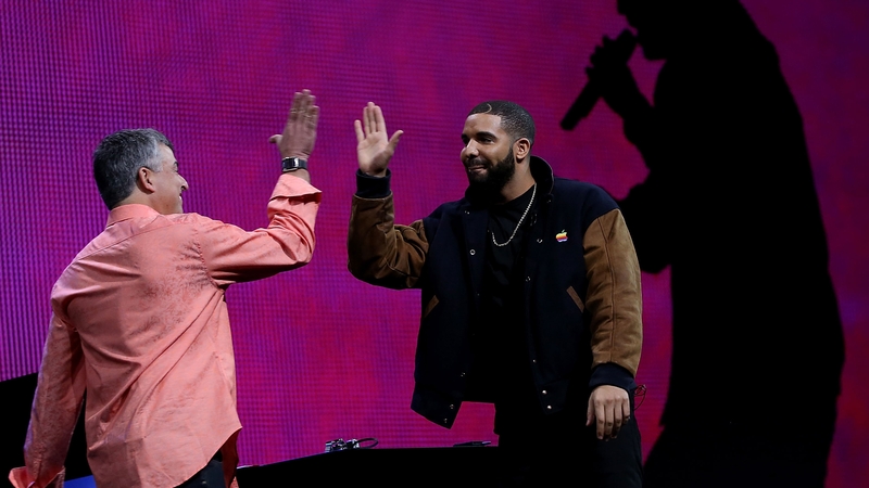 Drake and Apple Senior Vice-President of Internet Software and Services, Eddy Cue, high-five at the launch of Apple Music