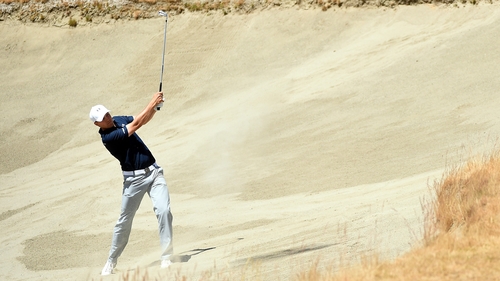 Jordan Spieth plays a bunker shot on the seventh hole