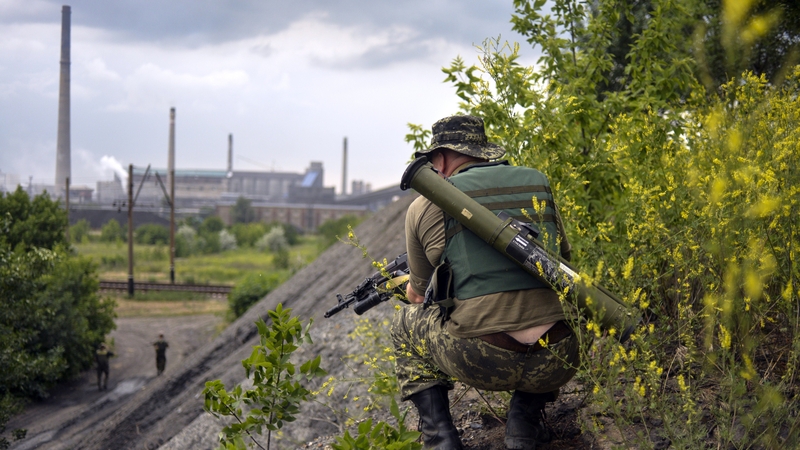 A Ukrainian soldier patrols near a chemical plant in Avdeevka, in the Donetsk region