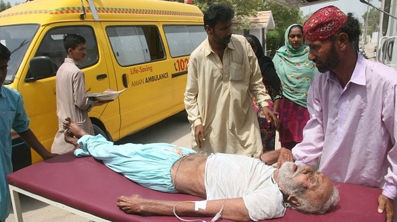 A man who was affected by the heatwave is taken to hospital for treatment