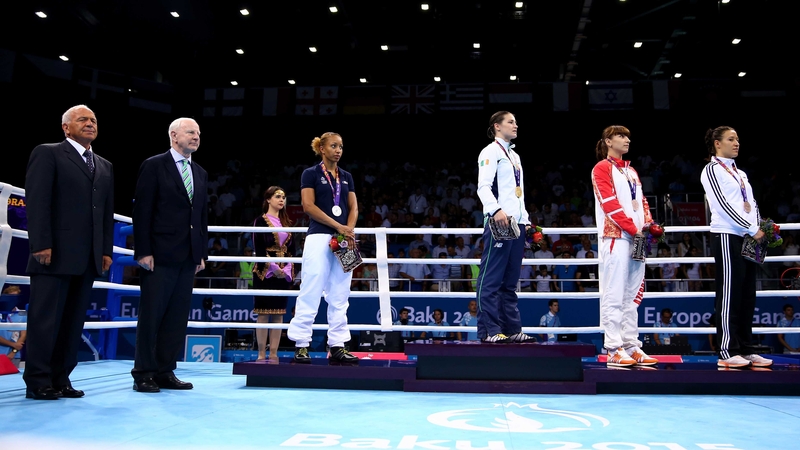 Katie Taylor stands to attention for Amhrán na bhFiann as Olympic Council of Ireland, and European Games, president Pat Hickey (second left) looks on