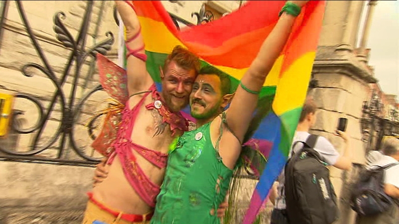 Many of those who attended the parade carried brightly coloured flags and posters referencing the passing of the same-sex marriage referendum