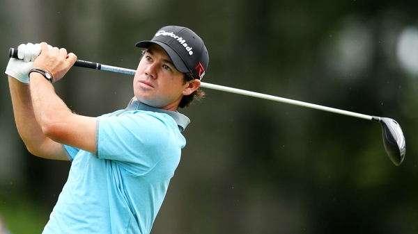 Brian Harman plays his shot from the 18th tee during the third round