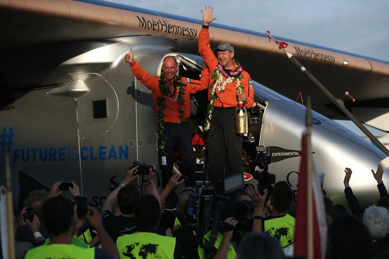Pilot co-founder Andre Borschberg (R) and his partner Bertrand Piccard (L) celebrate the landing of the Solar Impulse 2 in Honolulu