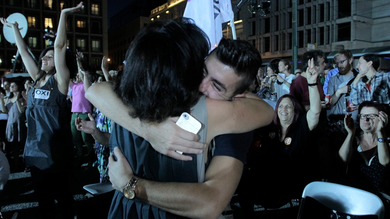 Supporters of the 'No' campaign react after the first results of the referendum in Athens