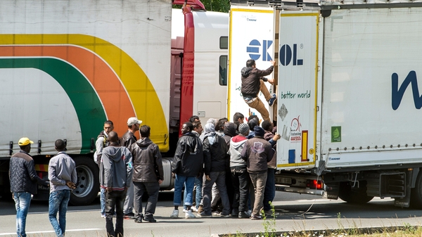 Migrants have been seen trying to climb onto trucks queuing in Calais