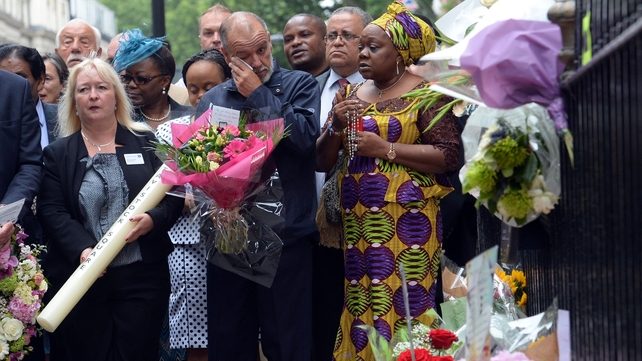 George Psaradakis (C), the driver of the number 30 bus that was blown up in Tavistock Square, looks at floral tributes left close to the scene of the bombings in London