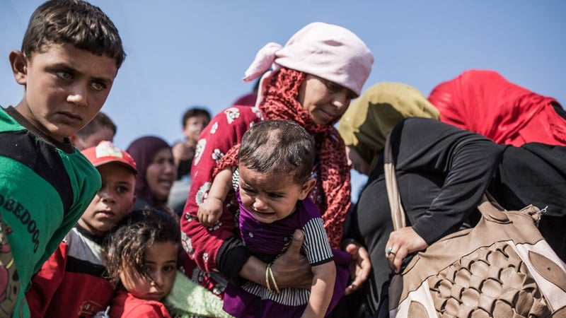 Syrian refugees cross the Syria-Turkey border last month