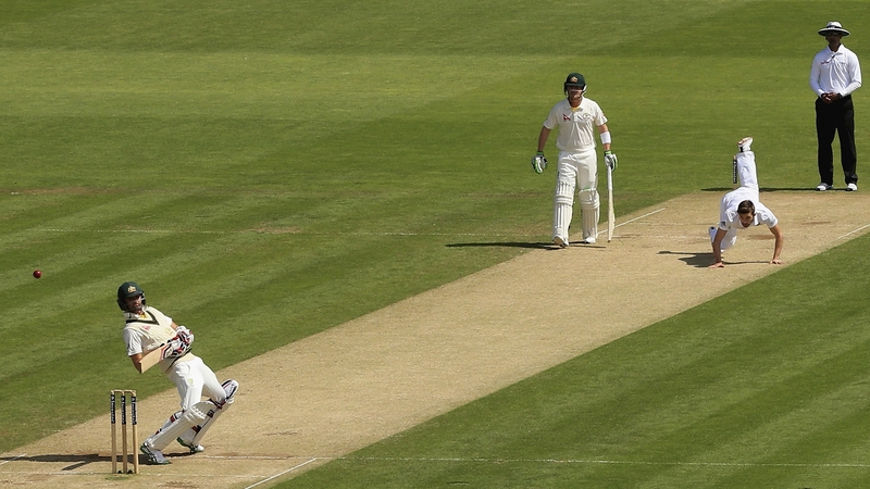 Mark Wood of England falls over as he bowls to Nathan Lyon