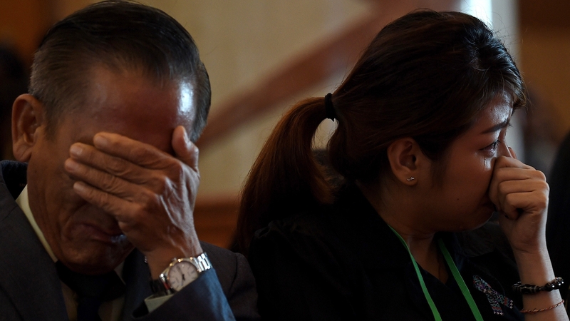 Grieving families observed a minute's silence at the service in Kuala Lumpur