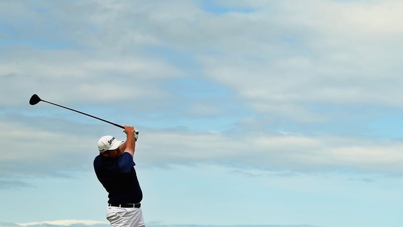 Shane Lowry hits a tee shot on the fourth hole