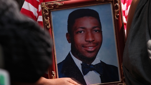 Eric Garner's mother holds his picture at a protest