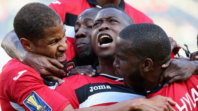 Sheldon Bateau of Trinidad & Tobago (centre) celebrates a first half goal against Guatemala with his team-mates including Radanfah Abu Bakr (left) and Khaleem Hyland (right) during a match in the 2015 CONCACAF Gold Cup at Soldier Field, Chicago