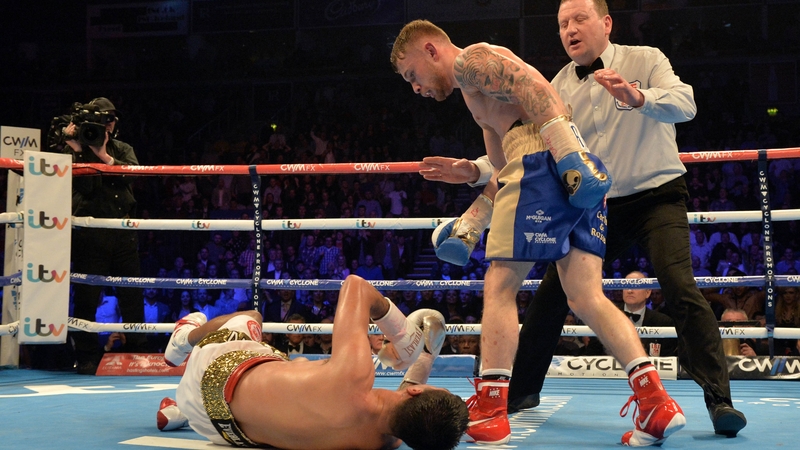 Carl Frampton knocks over Chris Avalos on his way to the IBF Super Bantamweight World Title