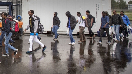 The first group of asylum seekers arrive by bus at Goes, Netherlands
