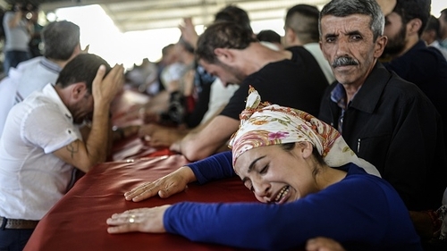 Mourners during a funeral ceremony for victims of the bomb attack in Suruc