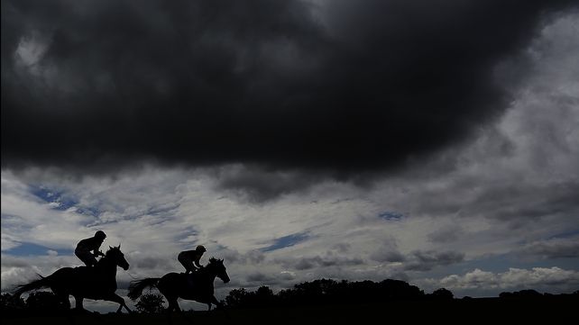 Two runners make their way to the starting line at Bath racecourse in England
