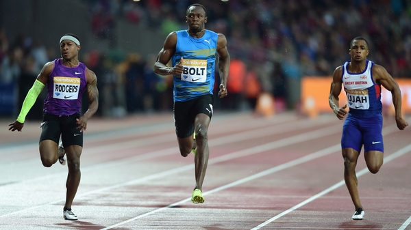 Usain Bolt of Jamaica (c) wins the Mens 100m Heat B