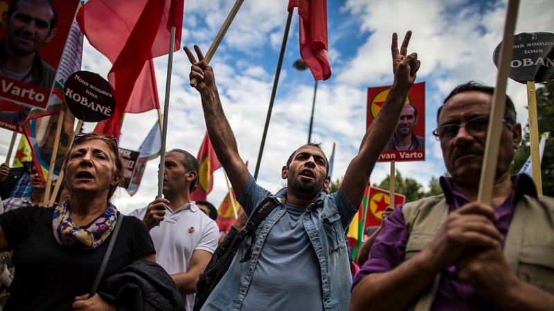Members of the Kurdish community hold a rally in Paris over Turkish air force attacks on the PKK military campaigns in Syria and northern Iraq